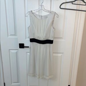 Elegant Cream Sleeveless Dress with Black Accent